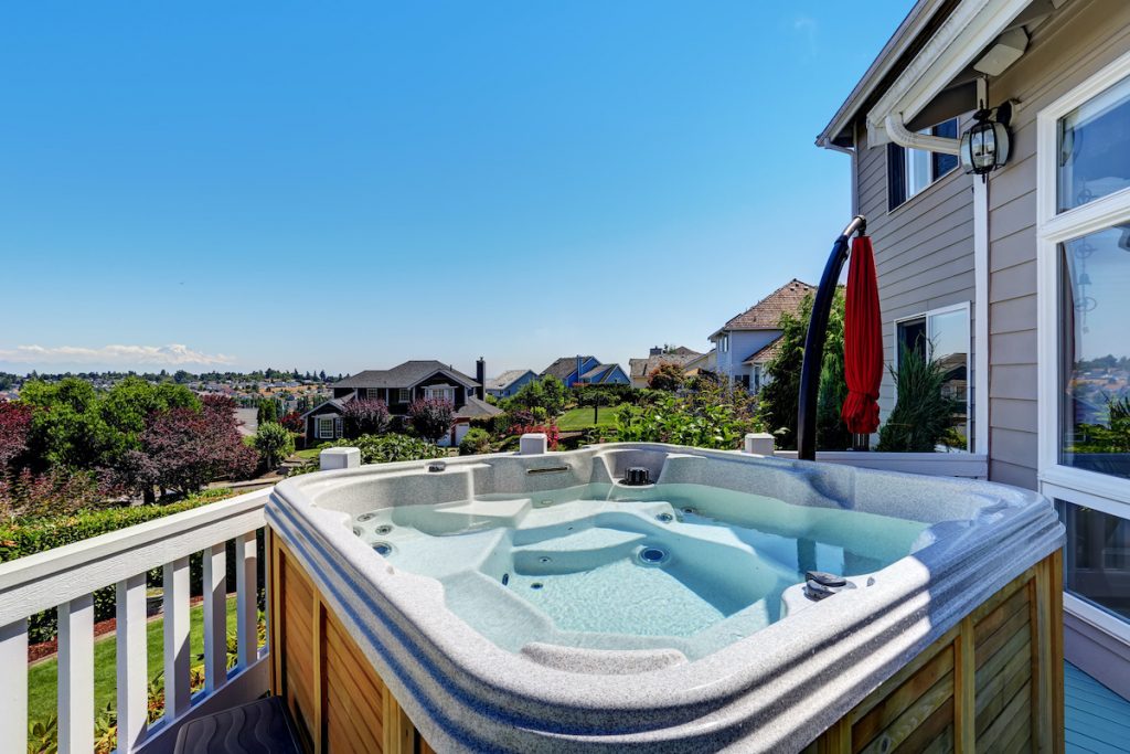 hot tub on backyard deck overlooking neighborhood